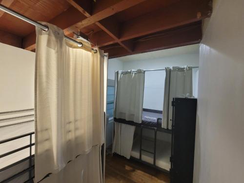 a bathroom with a shower curtain and a window at Roomi in Los Angeles