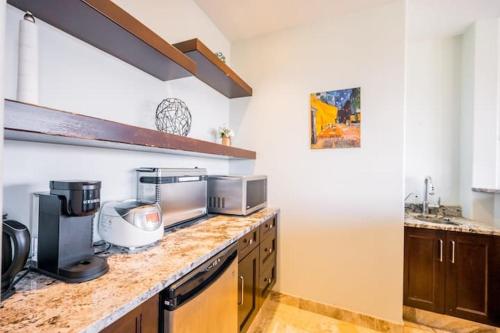 a kitchen with a counter top with a microwave at Lakeview 2-bed 2-bath Entire Suite near Summerhill Winery in Kelowna