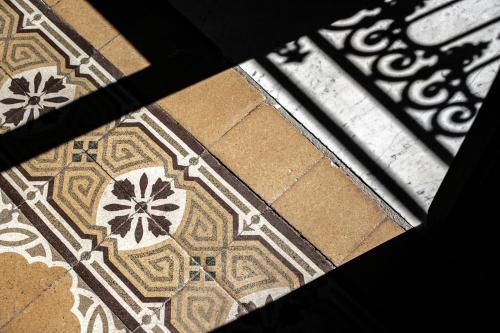 a view of a tile floor with flowers on it at Palazzo Villelmi in Cefalù