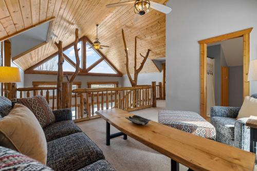 a living room with a couch and a table at Maple Lake Chalet in Buffalo