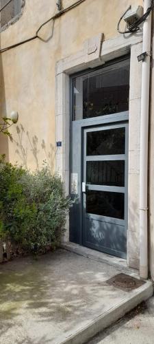 une porte de garage bleue sur un bâtiment dans l'établissement Mer&Soleil, à Sète