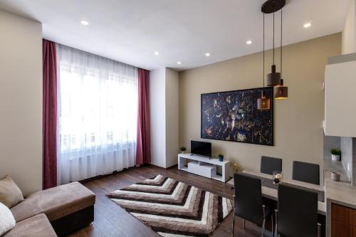 un salon avec un canapé, une table et une télévision dans l'établissement Central City Apt in the Jewish Quarter with FREE PARKING, à Budapest