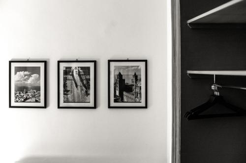 a group of four pictures on a wall at Palazzo Villelmi in Cefalù