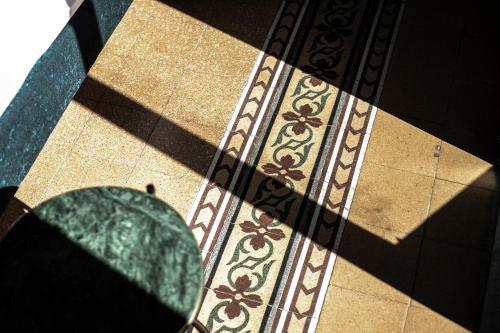 a shadow of a tile floor with a circle on it at Palazzo Villelmi in Cefalù
