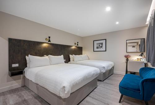 Postel nebo postele na pokoji v ubytování King's Cross Express Inn