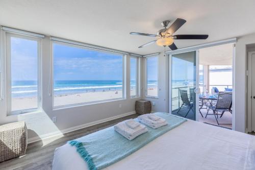 a bedroom with a bed with a view of the beach at B5026 Rockaway Oceanfront 2 in San Diego