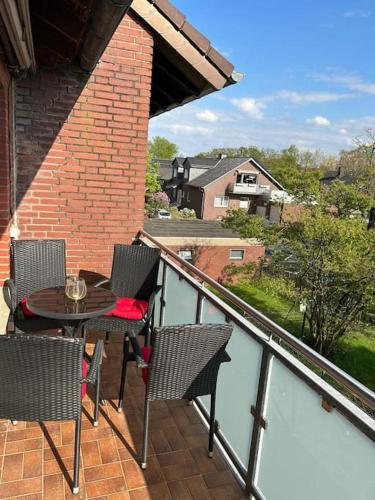 a patio with a table and chairs on a balcony at Fewo Stever-Aue in Lüdinghausen