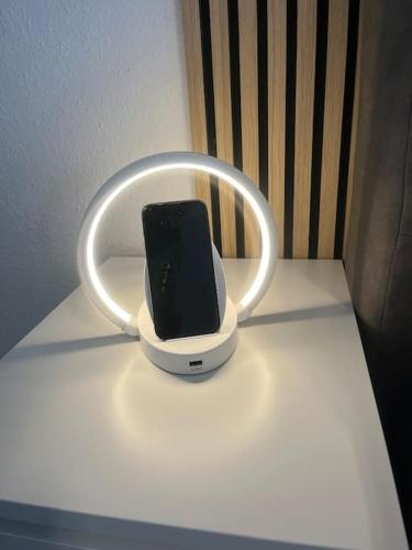 a cell phone in a holder on a table at Fewo Stever-Aue in Lüdinghausen