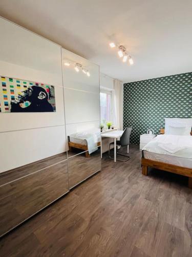 a bedroom with two beds and a table in it at Fewo Stever-Aue in Lüdinghausen