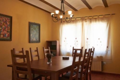 a dining room with a wooden table and chairs at CASA RURAL EL PINICO in Yeste