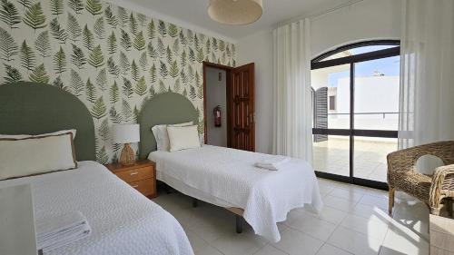 Ένα ή περισσότερα κρεβάτια σε δωμάτιο στο Casa Catarina