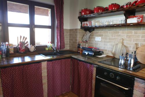 a kitchen with a sink and a counter top at Bakonyszentkirályi Menedék in Bakonyszentkirály