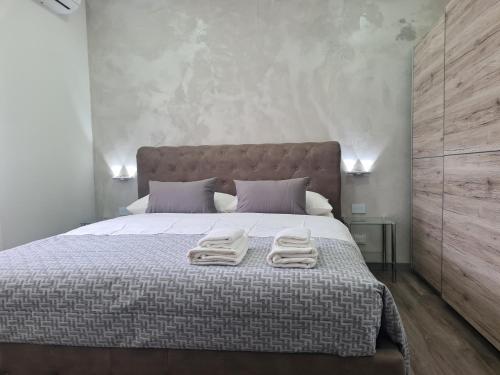 Apartment Udine في أوديني: غرفة نوم بسرير كبير عليها منشفتين