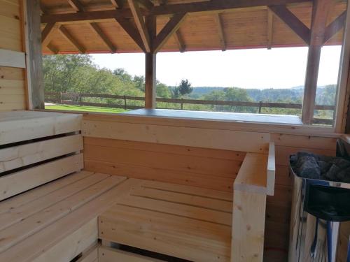 a sauna with a window in a wooden cabin at Bakonyszentkirályi Menedék in Bakonyszentkirály