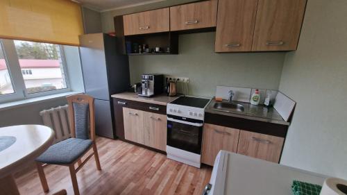 a small kitchen with a sink and a stove at Apartamenti dzīvoklis Ogre. in Ogre