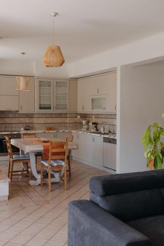 a kitchen and living room with a table and chairs at Lazarus 2BD Apartment in the Center in Patra