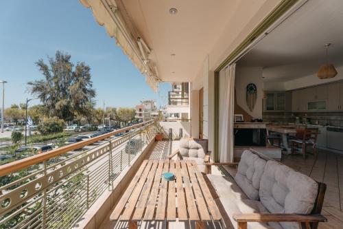 a living room with a wooden table on a balcony at Lazarus 2BD Apartment in the Center in Patra