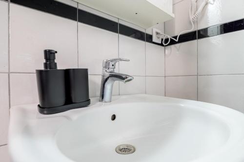 a bathroom sink with a faucet on top of it at Delfini Bliss 1 in Alexandroupoli