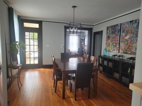 a dining room with a table and chairs at 1895 meets 2023 Townhouse. in Hamilton