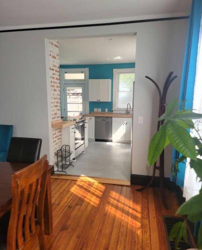 a living room with a kitchen and a dining room at 1895 meets 2023 Townhouse. in Hamilton