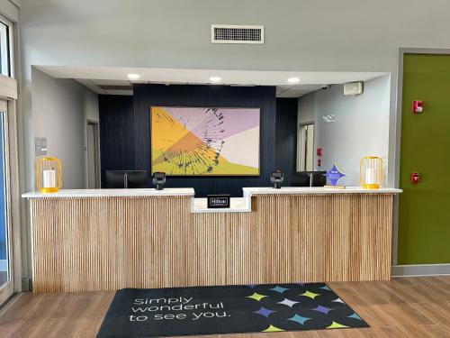 an office lobby with a reception desk with a presentation at Spark by Hilton Commerce, GA in Commerce