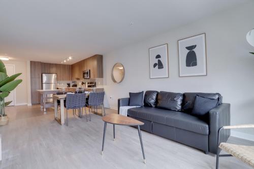 a living room with a blue couch and a table at Fun & Comfort Await: Apartment at Alexandria in Alexandria