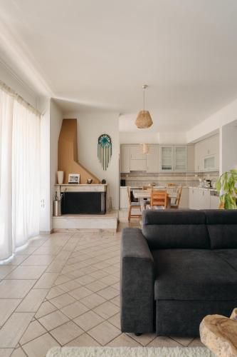 a living room with a couch and a kitchen at Lazarus 2BD Apartment in the Center in Patra