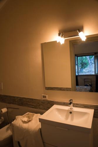 a bathroom with a sink and a mirror at Villa Caterina in Imperia