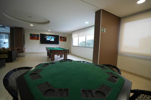 a room with a ping pong table and a projection screen at Wyndham Golden Foz Suítes in Foz do Iguaçu
