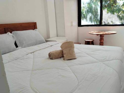 a large white bed with two pillows on it at Kathy's Place at Cold Spring in Catarman