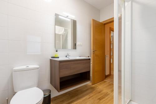 a bathroom with a toilet and a sink at INSIDEHOME Ciudad de Avilés in Avilés