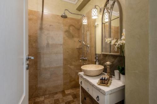 a bathroom with a sink and a shower at Apartament La Plaja in Mamaia Nord