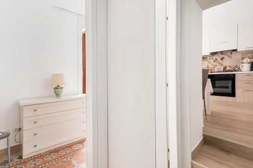 a kitchen with white cabinets and a stove at La Maison de La Mer in Cefalù