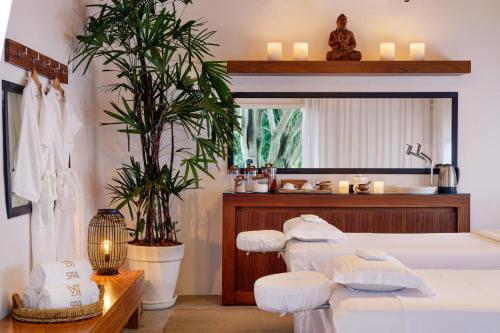 a bedroom with a bed and a bathroom with a sink at Vila Santa Teresa in Rio de Janeiro