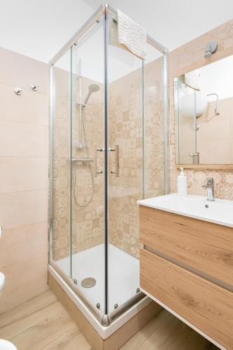 a bathroom with a shower with a sink and a toilet at La Maison de La Mer in Cefalù