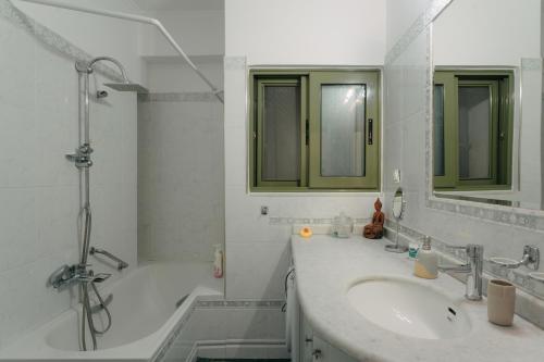 W łazience znajduje się wanna, umywalka i prysznic. w obiekcie Lazarus 2BD Apartment in the Center w mieście Patras