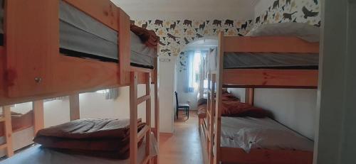 a dorm room with two bunk beds and a hallway at Quinoa Backpackers Hostel in Lima