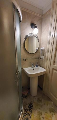 a bathroom with a sink and a mirror at Affittacamere Museo in Taranto