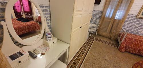 a room with a mirror and a bed in it at Affittacamere Museo in Taranto