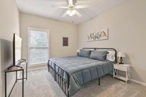 a bedroom with a bed and a ceiling fan at Tiger's Den On Dean in Auburn