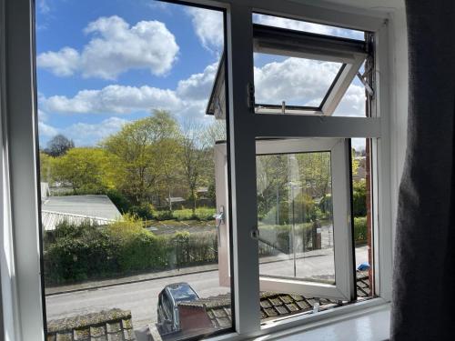 an open window with a view of a yard at Homestay-Close to Coventry City and University I Free Parking I Wi-Fi in Coventry