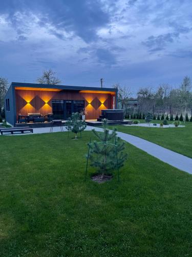 a house with lights on the side of it at Holiday house near the city in Būdviečiai