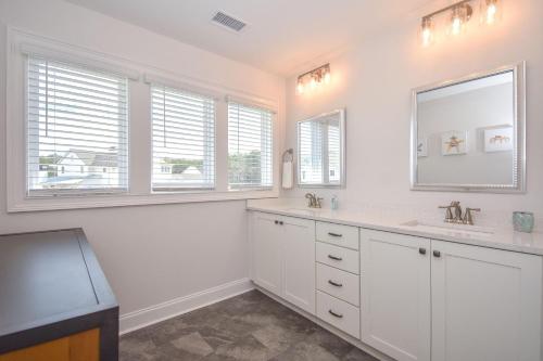 a white bathroom with a sink and a mirror at Changes In Latitude in Dadeville
