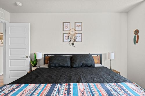 a bedroom with a bed with a black comforter at Uptown Avenue - Broomfield in Broomfield