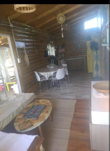 a living room with a table and a dining room at Cabaña Gaia in Los Cocos