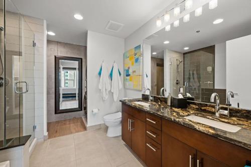 a bathroom with a sink and a toilet and a shower at Spire - Unit 1810 in Denver