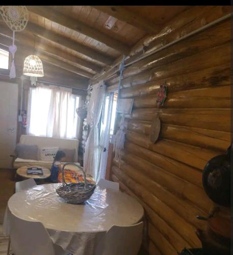 a table in a room with a wooden wall at Cabaña Gaia in Los Cocos