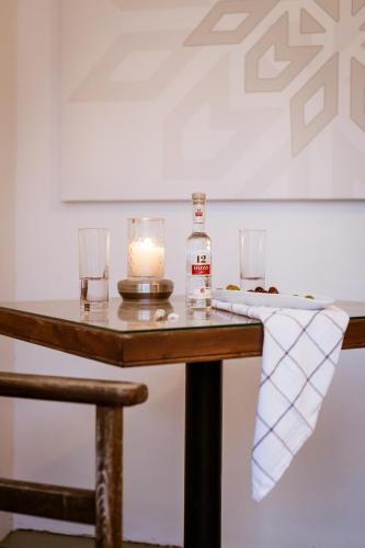 a bottle of whiskey and a candle on a table at Utopia Luxury Suites - Old Town in Rhodes Town