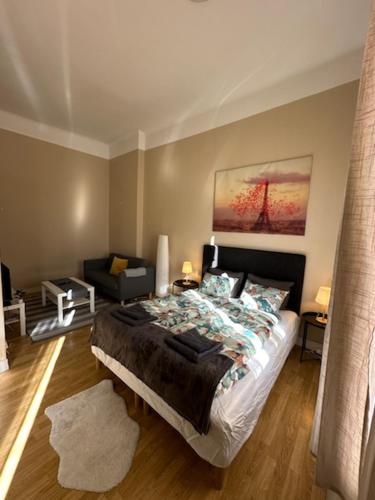 a bedroom with a bed and a living room at Rentalux Apartments at Nytorget in Sundsvall
