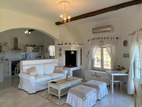 a living room with a white couch and a table at Ocean Garden, 4 units by the ocean in São Vicente